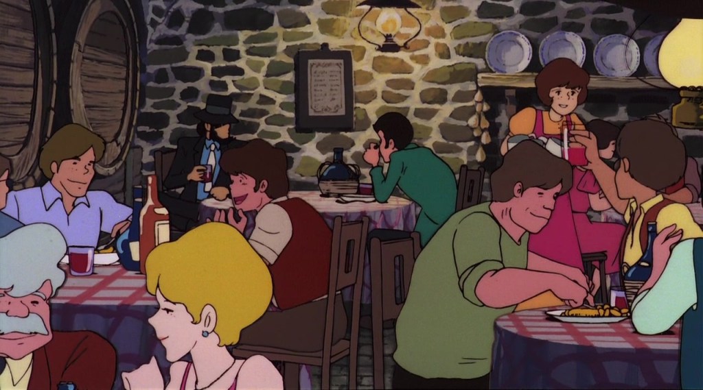 Uma cena animada em um restaurante rústico, com várias mesas ocupadas por clientes conversando e desfrutando de refeições. O ambiente é acolhedor, com paredes de pedra e decoração simples. Um garçom serve uma mesa.